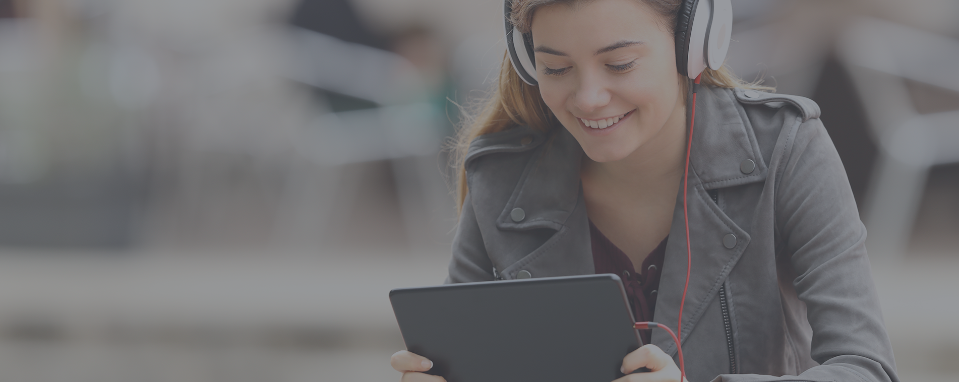 young woman listening to a podcast on her tablet